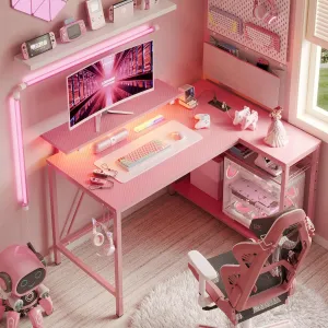 Bestier Gaming Desk with Power Outlets, 42" L-Shaped Gaming Desk with LED Lights, Desk with Reversible Storage Shelves & Hooks for Small Spaces, Bedrooms & Offices,Pink Carbon Fiber